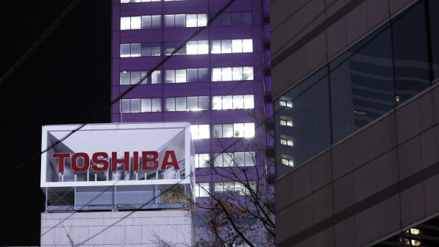 Signage for Toshiba Corp. displayed at the company's headquarters at night in Tokyo, Japan, on Monday, Dec. 19, 2022. Toshiba's shares dropped on a report that the company's preferred bidder may lower its valuation. The iconic Japanese conglomerate has been exploring options for its future including going private. Photographer: Kiyoshi Ota/Bloomberg