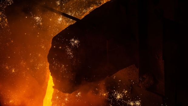 Sparks fly from molten iron flowing from the only operational blast furnace at the ArcelorMittal SA steel plant in Kryvyi Rih, Ukraine, on Wednesday, June 29, 2022. ArcelorMittal's Kryvyi Rih steel plant is running just the smallest of its four gas and coke-fired blast furnaces to make pig iron, as a result some mines and coking plants that feed the plant also must remain dormant, "Without the ports, it doesn't work." said Deputy Chief Executive Artem Filipyev. Photographer: Julia Kochetova/Bloomberg