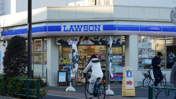 A cyclist travels past a Lawson Inc. convenient store at dusk in Tokyo, Japan, on Wednesday, Jan. 5, 2022. Lawson will release its earnings figures on January 7.