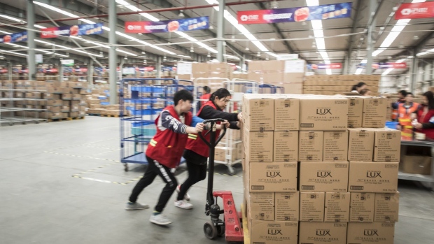 Employees move a pallet loaded with boxes of Unilever NV's Lux products at Best Inc.'s warehouse in Shanghai, China, on Monday, Nov. 6, 2017. Best, the Chinese logistics provider backed by Alibaba Group Holding Ltd., is scouting for acquisitions of technology companies both in China and the U.S. that will help it boost efficiency and break even as early as next year. Photographer: Qilai Shen/Bloomberg