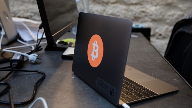 A Bitcoin logo on a laptop. Photographer: Marlene Awaad/Bloomberg