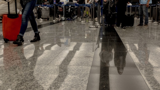 Travelers arrive at Ezeiza International Airport (EZE) as quarantine restrictions are lifted in Buenos Aires, Argentina, on Monday, Nov. 1, 2021. Starting Nov. 1, Argentina has lifted restrictions to enter and exit the country from international airports. Photographer: Erica Canepa/Bloomberg