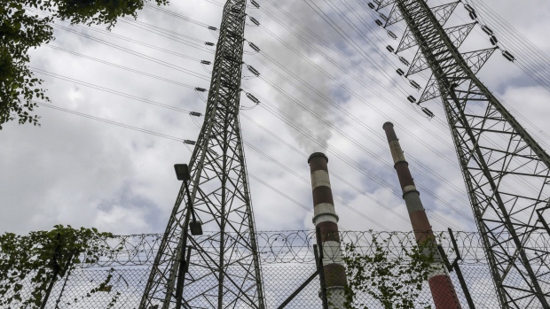 Smoke rises from a chimney as electricity pylons stand at the Tata Power Co. Trombay Thermal Power Station in Mumbai, India.
