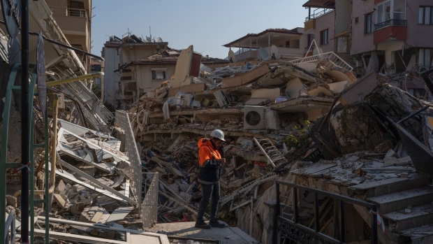 A rescue worker at the site of collapsed residential buildings in Hatay, Turkey, on Sunday, Feb. 12, 2023. The two massive earthquakes that killed over 24,000 people in Turkey are expected to result in an loss to the nation’s economy of over $84 billion, or about 10% of the GDP, according to estimates of the Turkish Enterprise and Business Confederation.