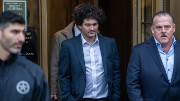 Sam Bankman-Fried, co-founder of FTX Cryptocurrency Derivatives Exchange, center, departs court in New York, US, on Tuesday, Jan. 3, 2023. Bankman-Fried pleaded not guilty to criminal charges Tuesday and is set to face a trial in October, a courtroom showdown likely to be one of the highest-profile white-collar fraud cases in recent years. Photographer: Jeenah Moon/Bloomberg