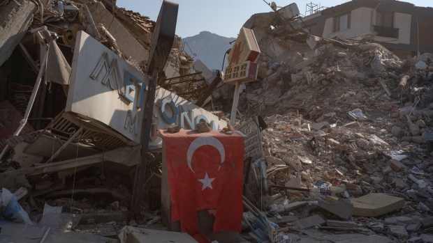 A Turkish national flag placed at the site of a collapsed building in Hatay, Turkey, on Sunday, Feb. 12, 2023.