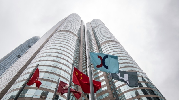 A Hong Kong Exchanges and Clearing Ltd. (HKEx) flag, second right, in Hong Kong, China, on Friday, Dec. 16, 2022. A pair of Hong Kong exchange-traded funds investing in Bitcoin and Ether futures raised $79 million as the city pushes ahead with a plan to become a crypto hub even as the sector globally reels from the FTX collapse. Photographer: Paul Yeung/Bloomberg