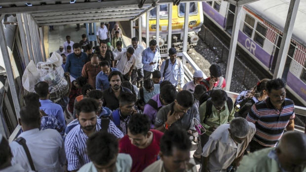 Commuters walk up a pedestrian overpass at Masjid Bunder train station in Mumbai, India, on Thursday, Aug. 29, 2019. Credit analysts are keeping a watchful eye on signs of stress in Indian household debt after unemployment rose to a 45-year high and as lenders grapple with the worst soured debt levels of any major economy. Photographer: Dhiraj Singh/Bloomberg
