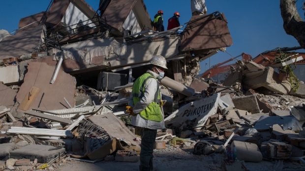 Volunteers work at the site of a collapsed building in Hatay, Turkey, on Tuesday, Feb. 14, 2023. Turkey’s public finances were improving in the month before the country’s deadliest earthquakes in almost a century, giving authorities headroom to marshal fiscal measures to cope with the devastation.