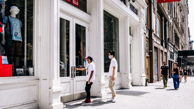 Shoppers wearing protective masks enter a Uniqlo Co. store in the Soho neighborhood of New York, U.S., on Thursday, Aug. 6, 2020. The Bloomberg Consumer Comfort index rose last week to 44.9 from 44.3 a week earlier. Photographer: Nina Westervelt/Bloomberg