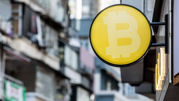 The Bitcoin logo in Hong Kong. Photographer: Paul Yeung/Bloomberg