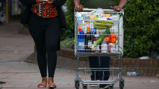 A customer pushes a shopping trolley full of groceries at an Aldi Stores Ltd. supermarket in London, UK, on Friday, June 24, 2022. The Office for National Statistics said Friday the volume of goods sold in stores and online fell 0.5% in May, as soaring food prices forced consumers to cut back on spending in supermarkets. Photographer: Hollie Adams/Bloomberg