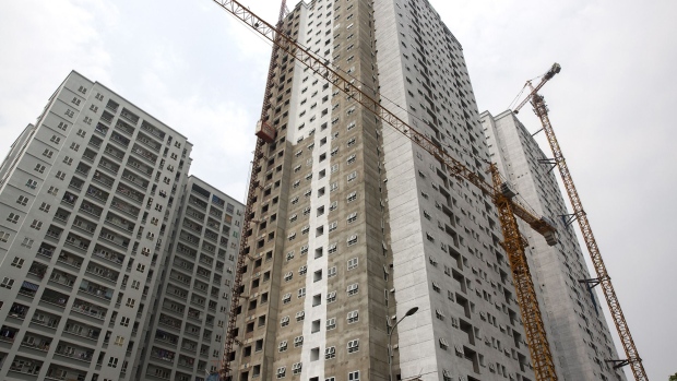 Cranes stand next to residential buildings under construction in Hanoi, Vietnam, on Tuesday, Sept. 11, 2018. The nation of 96 million people has embraced free-market reforms over the past few decades, leading to surging growth under an authoritarian one-party Communist government that offers the same political stability as China. Photographer: Maika Elan/Bloomberg