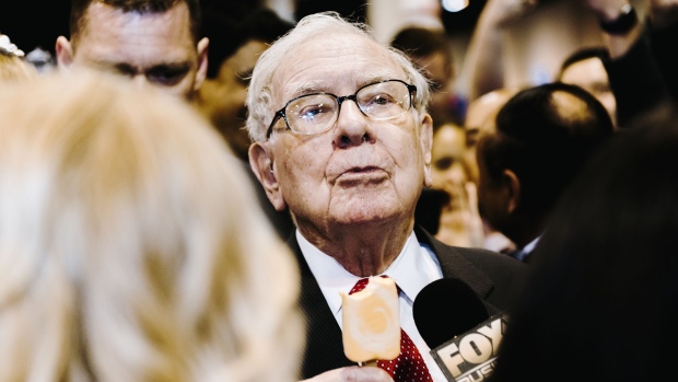 Warren Buffett, chairman and chief executive officer of Berkshire Hathaway Inc., eats a Dairy Queen vanilla orange ice cream bar while touring the shopping floor ahead of the company's annual meeting in Omaha, Nebraska, U.S., on Saturday, May 4, 2019. Buffett's Berkshire Hathaway agreed earlier this week to make the investment in Occidental to help the oil producer with its $38 billion bid for Anadarko Petroleum Corp. Photographer: Houston Cofield/Bloomberg