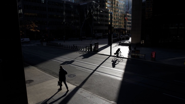 Commuters outside the TD Tower in the financial district of Toronto, Ontario, Canada, on Monday, Nov. 22, 2021. Many of Canada’s large financial firms say they have a growing portion of their workforces back in the office and the numbers are expected to swell in the New Year. Photographer: Cole Burston/Bloomberg