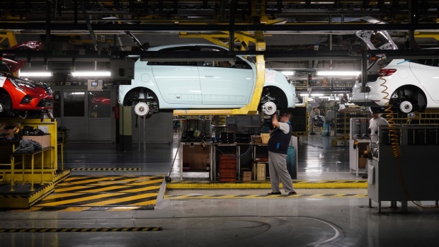 An employee inspects a Renault Twingo automobile in an overhead conveyor cradle on the production line at the Renault Revoz d.d. plant, a unit of Renault SA, in Novo Mesto, Slovenia, on Wednesday, Nov. 16, 2022. Renault last week presented a radical overhaul plan to investors, proceeding with a complex split of Renault's electric-vehicle and combustion-engine businesses. Photographer: Oliver Bunic/Bloomberg