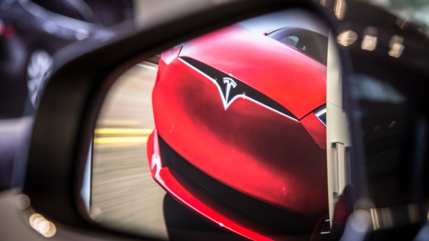A badge sits on the hood of a Model S electric vehicle displayed inside a Tesla Inc. store in Barcelona, Spain, on Thursday, July 11, 2019. Tesla is poised to increase production at its California car plant and is back in hiring mode, according to an internal email sent days after the company wrapped up a record quarter of deliveries.