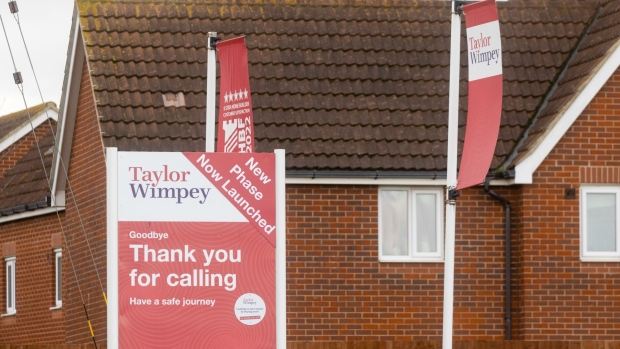 Signs at the entrance to a Taylor Wimpey Plc residential housing construction site in Hoo, UK, on Monday, Jan. 9, 20233. Taylor Wimpey is due to give a trading update on Friday.