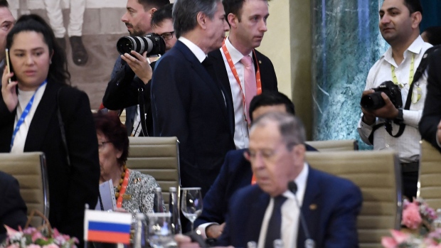 Antony Blinken walks past Sergei Lavrov during G-20 foreign ministers meeting in New Delhi. Photographer: Olivier Douliery/AFP/Getty Images