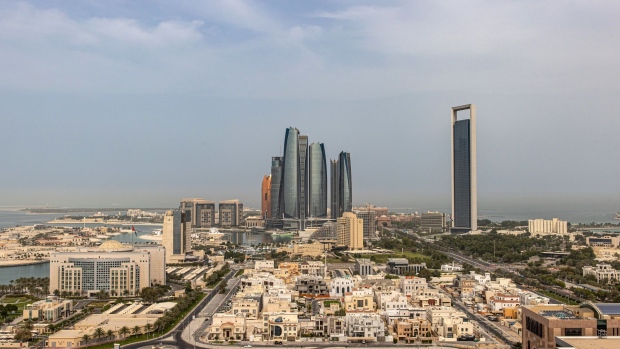 The headquarters of the Abu Dhabi National Oil Co. (ADNOC), right, and Etihad Towers, center, surrounded by residential and commercial properties in Abu Dhabi, United Arab Emirates, on Sunday, April 10, 2022. Abu Dhabi regulators approved a framework for special purpose acquisition companies, looking to capture some of the blank-check boom that has gripped global markets for the past two years.