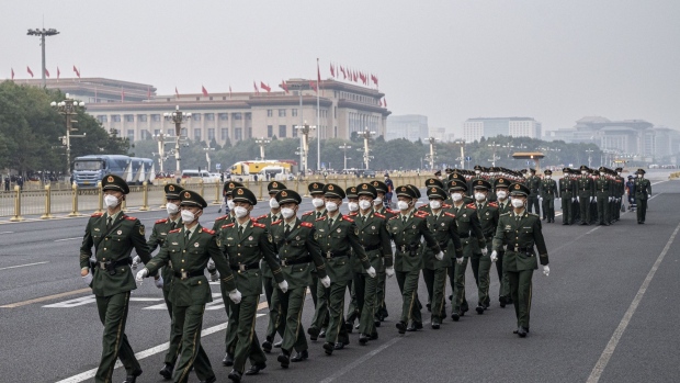People's Liberation Army soldiers march along a road at the end of the flag raising ceremony during National Day in Beijing, China, on Saturday, Oct. 1, 2022. Beijing’s Covid Zero strategy remains a major threat to growth, with key cities like Chengdu only recently emerging from lockdowns. Tourism has been decimated and travel during the upcoming National Day holidays in October is being discouraged.