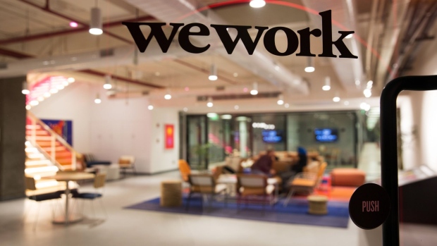 Signage is displayed at the WeWork Cos. 32nd Milestone co-working space in Gurugram, India, on Monday, Feb. 18, 2019. The New York-based co-working giant WeWork Cos, which operates shared office spaces around the world, has attracted huge piles of investor money, which it uses to snap up office space in the largest cities on earth.