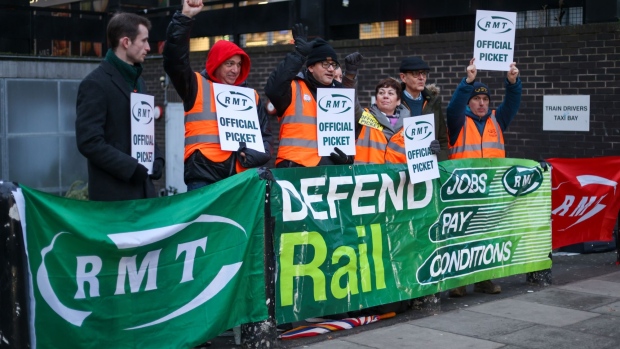 Members of the National Union of Rail, Maritime and Transport (RMT) on a picket line during strike action outside London Euston railway station on Jan. 3, 2023.