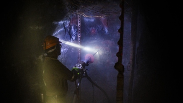 A miner operates drilling machinery in the mine shaft during a media tour of the Sibanye-Stillwater Khuseleka platinum mine, operated by Sibanye Gold Ltd., outside Rustenburg, South Africa on Wednesday, Oct. 16 2019. Sibanye said it’s on track to resume paying dividends next year, should the company settle a wage dispute with platinum-mine workers without too much disruption. Photographer: Waldo Swiegers/Bloomberg