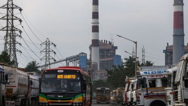 A bus travels past trucks and tankers lining a road near the Tata Power Co. Trombay Thermal Power Station in Mumbai, India, on Wednesday, Oct. 6, 2021. India is grappling with an escalating crisis as stockpiles of coal, the fuel used to generate about 70% of the nation’s electricity, dwindle to the lowest in years just as power demand is set to surge. Photographer: Dhiraj Singh/Bloomberg