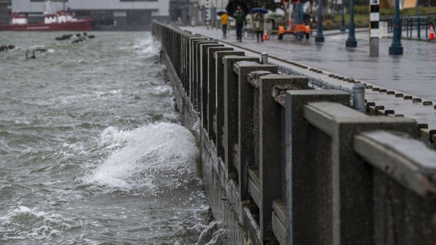 Water breaks on the seawall along the Embarcadero during a rain storm in San Francisco on March 9.