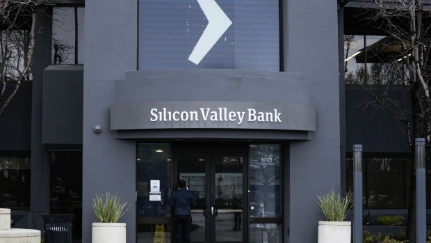 A customer reads a press release at the entrance of the Silicon Valley Bank headquarters in Santa Clara, on Friday. Photographer: Philip Pacheco/Bloomberg