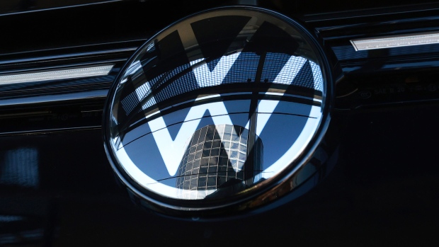 An Autostadt delivery tower reflected in the badge of a Volkswagen AG (VW) Golf automobile at the automaker's headquarters and auto plant in Wolfsburg, Germany, on Tuesday, Feb. 28, 2023. Volkswagen wants to remain a strong player in Europe and China, but in the face of growing geopolitical tensions and an increasingly complex regulatory environment, the German carmaker is looking beyond the US for markets with growth potential. Photographer: Krisztian Bocsi/Bloomberg