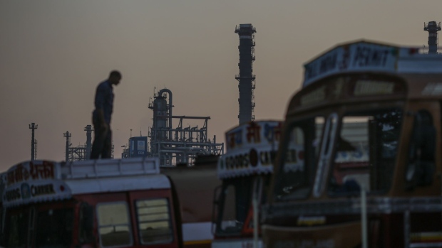 A truck driver stands on a truck near an oil refinery, operated by Bharat Petroleum Corp. Ltd., in Mumbai, India, on Saturday, Dec. 10, 2022. A senior official at India's oil ministry told reporters this month India has been buying oil from about 30 countries, and will continue to buy from anywhere including Russia beyond January. Photographer: Dhiraj Singh/Bloomberg