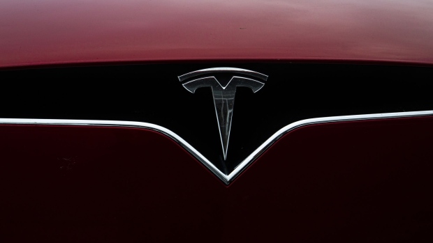 A logo is displayed on a Tesla Inc. electric vehicle charging at the Tesla Supercharger station in Fremont, California, U.S., on Monday, July 20, 2020. Tesla Inc. is scheduled to release earnings figures on July 22. Photographer: Nina Riggio/Bloomberg