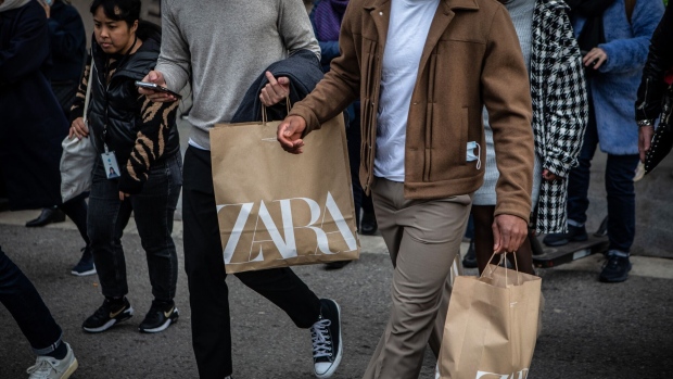 Shoppers carry Zara branded bags on Passeig de Gracia in Barcelona, Spain, on Friday, Dec. 16, 2022. Consumer prices across Spain eased for a fourth month in a row in November to 6.7% as gasoline and energy prices continued to fall. Photographer: Angel Garcia/Bloomberg