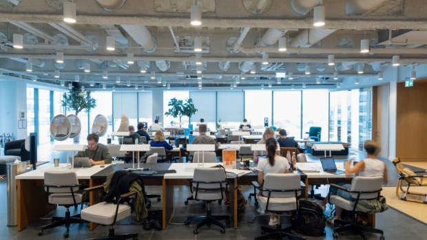 Office workers at desks in a WeWork co-working office space in the Waterloo district in London, U.K. on Monday, Aug. 2, 2021. A survey this month showed that just 17% of London’s white-collar workers want a full-time return, and many said it’d take a pay rise to get them back five days a week.