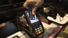 A customer uses a credit card to make a contactless payment on a Verifone Systems Inc. payment device in London, U.K., on Friday, May 22, 2015. Credit and debit cards that can be used by tapping the reader are gaining users, and mobile apps are set to further boost the popularity of contactless paying. Photographer: Simon Dawson/Bloomberg