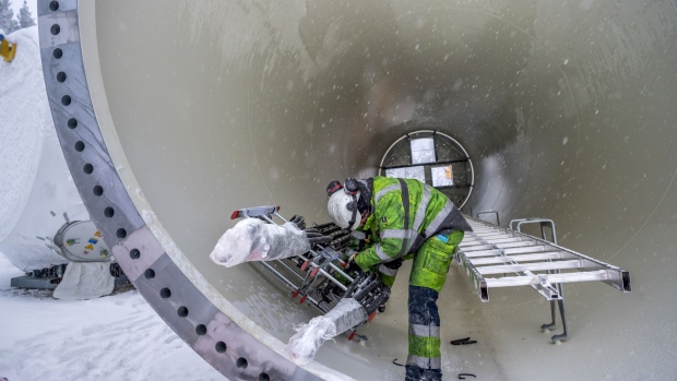 A contractor works inside a wind turbine tower waiting to be installed at the Markbygden ETT wind park project near Pitea, Sweden, on Tuesday, Nov. 12, 2019. Workers are installing turbines perched atop 130-meter tall towers at a rate of about two a week at the site in northern Sweden, where the temperature regularly dips below minus 10 Celsius (14 Fahrenheit) and the sun is hardly seen for months on end during winter. Photographer: Mikael Sjoberg/Bloomberg