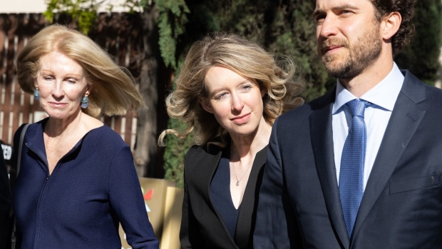 Elizabeth Holmes, founder of Theranos Inc., arrives at federal court with her partner Billy Evans, right, and her mother Noel Holmes, left, in San Jose, California, US, on Friday, March 17, 2023. Holmes made her final appearance before the federal judge who sentenced her to 11 1/4 years in prison for defrauding Theranos investors. She's scheduled to report to prison next month, but is asking to remain free on bail while she appeals her conviction and sentence.