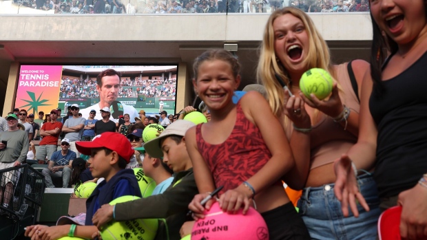Fans show off their signed tennis balls during the BNP Paribas Open on March 11. Photographer: Julian Finney/Getty Images