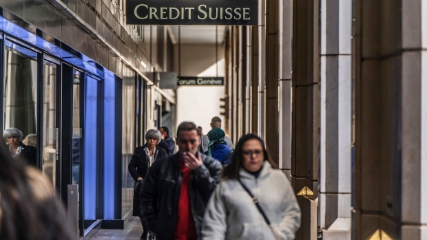 Pedestrians outside a Credit Suisse Group AG bank branch in Geneva, Switzerland, March 16. Photographer: Bloomberg/Bloomberg