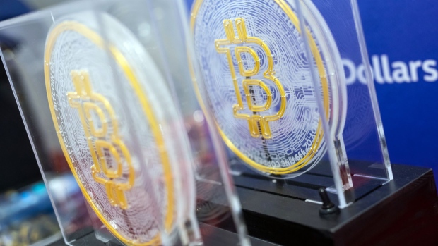 The Bitcoin logo on souvenirs during the listing ceremony for the CSOP Bitcoin Futures and CSOP Ether Futures exchange-traded funds (ETFs) at the Hong Kong Stock Exchange in Hong Kong, China, on Friday, Dec. 16, 2022. A pair of Hong Kong ETFs investing in Bitcoin and Ether futures raised $79 million as the city pushes ahead with a plan to become a crypto hub even as the sector globally reels from the FTX collapse. Photographer: Paul Yeung/Bloomberg