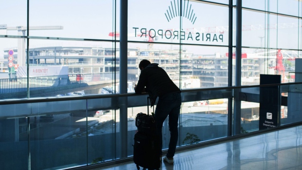 A traveler uses a smartphone in Terminal 3 at Orly Airport, operated by Aeroports de Paris, in Paris, France, on Tuesday, April 27, 2021. France is moving toward a broad rollout of digital health certificates, putting the country at the forefront of a European Union push for vaccine passports to jumpstart travel.