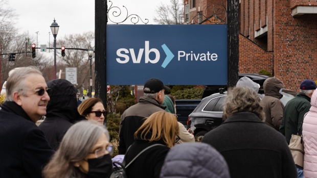 Customers wait in line outside of a Silicon Valley Bank branch in Wellesley, Massachusetts, US, on Monday, March 13, 2023. The collapse of Silicon Valley Bank has prompted a global reckoning at venture capital and private equity firms, which found themselves suddenly exposed all together to the tech industry's money machine.