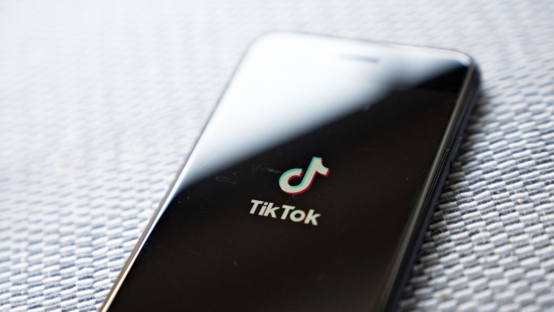 Signage for ByteDance Ltd.'s TikTok app is displayed on a smartphone in an arranged photograph taken in Arlington, Virginia, U.S., on Monday, Aug. 3, 2020. In a bid to salvage a deal for the U.S. operations of TikTok, Microsoft Corp. Chief Executive Officer Satya Nadella spoke with President Donald Trump by phone about how to secure the administrations blessing to buy the wildly popular, but besieged, music video app.