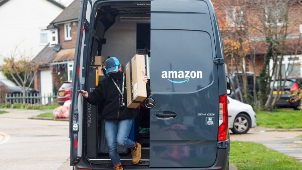 An Amazon.com Inc. delivery driver takes an order from a delivery van in Westcliff-on-Sea, U.K., on Thursday, Nov. 26, 2020. With Black Friday almost underway, equity traders are bracing for a holiday season where brick-and-mortar businesses that lack strong digital platforms could suffer. Photographer: Chris Ratcliffe/Bloomberg