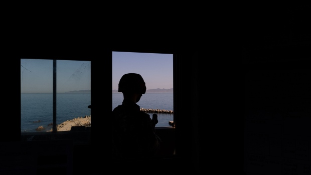 A South Korean Marine Corps soldier looks across the sea towards the North Korean territory of Changsan Cape, rear, from a military check point on Baengnyeong Island, Incheon, South Korea, on Tuesday, March 30, 2021. Ever since fighting ended in the Korean War nearly seven decades ago, Baengnyeong has been a key location for U.S. allies in Seoul to spy on North Korea. Yet now the island is on China's radar. Photographer: SeongJoon Cho/Bloomberg
