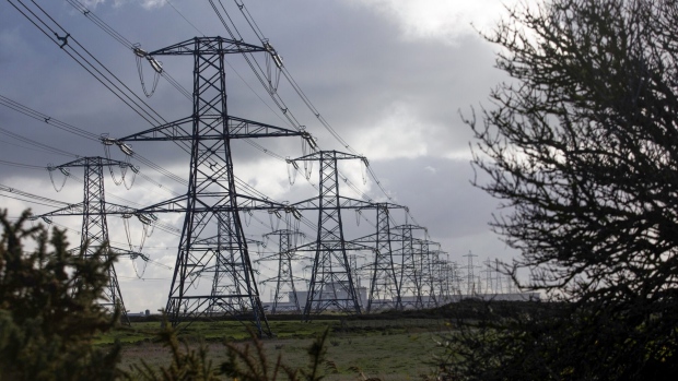 Electricity transmission pylons near Dungeness nuclear power plant, operated by Electricite de France SA (EDF), in Dungeness, U.K., on Monday, Oct. 26, 2020. The U.K.'s power supply buffer is set to shrink this winter compared to last year due to outages at power plants and the unexpected closure of two of Calon Energy Ltd.'s gas-fired stations after the company went into administration. Photographer: Chris Ratcliffe/Bloomberg