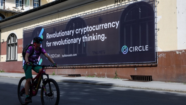 A cyclist passes a banner for Circle, a cryptocurrency company, ahead of the World Economic Forum (WEF) in Davos, Switzerland, on Saturday, May 21, 2022. The annual Davos gathering of political leaders, top executives and celebrities runs from May 22 to 26. Photographer: Hollie Adams/Bloomberg