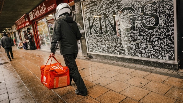 A food delivery courier carries a Just Eat Takeaway.com NV bag in Crawley, UK, UK, on Wednesday, Nov. 16, 2022. UK inflation rose more than expected to a 41-year high of 11.1%, adding to pressure on the Bank of England to raise interest rates again.